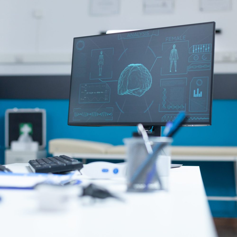 Empty doctor office with computer having anatomical body skeleton radiography on computer screen during clinical consultation. Hospital room equipped with professional medical tools. Medicine concept