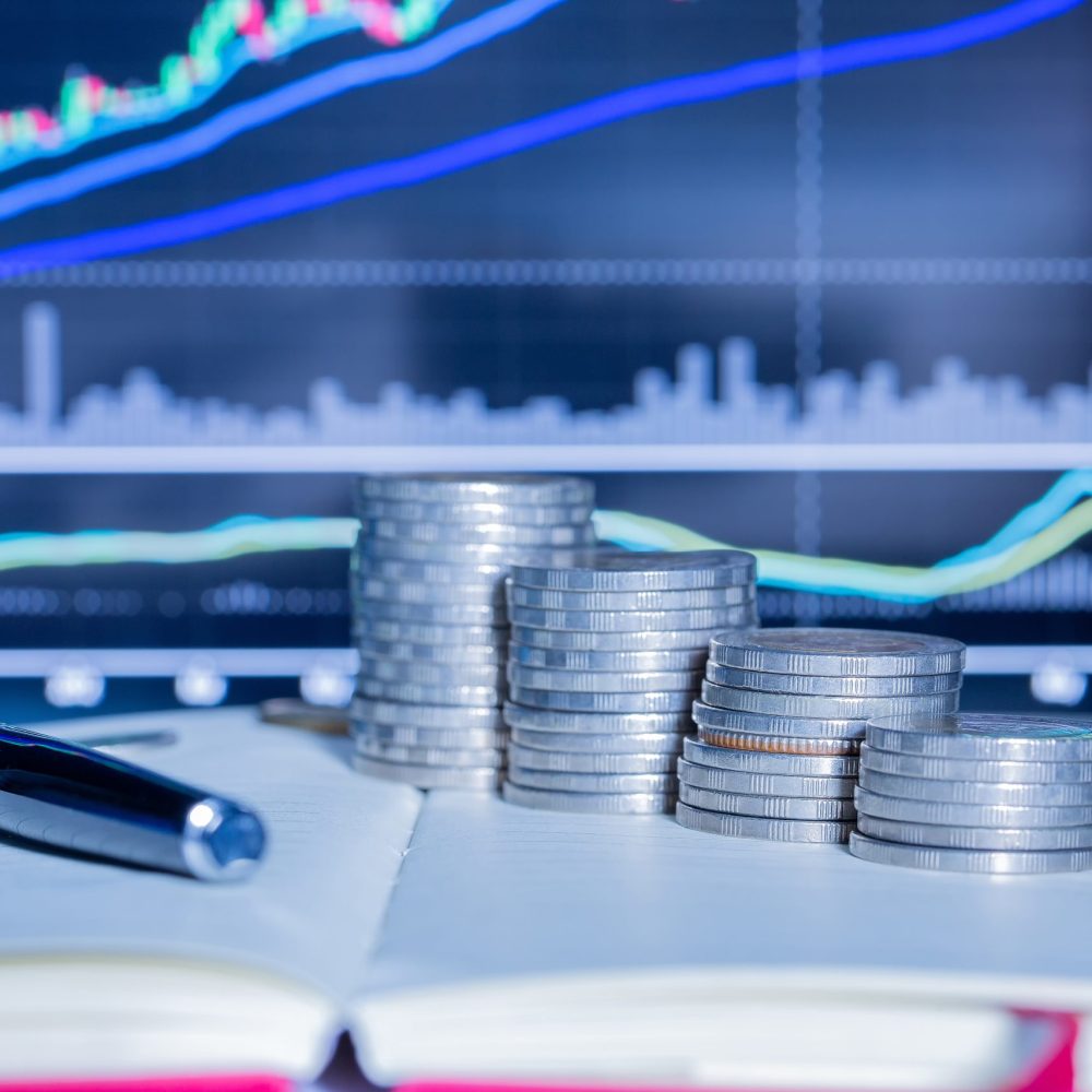 Stack of money coin with trading graph. financial investment concept use for background.